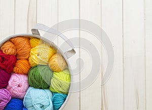 Yarn for knitting rainbow. Wood background