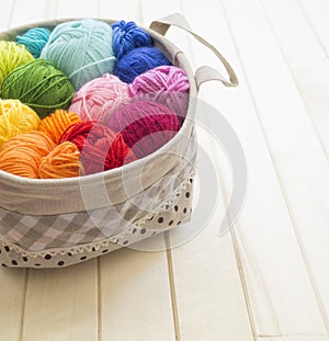 Yarn for knitting rainbow. Wood background