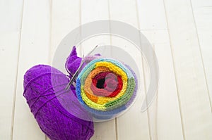 Yarn for knitting rainbow. Wood background