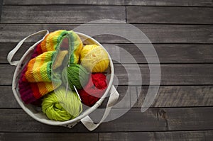 Yarn for knitting rainbow. Wood background