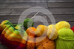 Yarn for knitting rainbow. Wood background