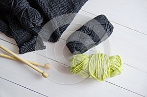 Yarn for knitting on white wooden background. The concept of Hobbies, crafts, the beginning of a new knitting project