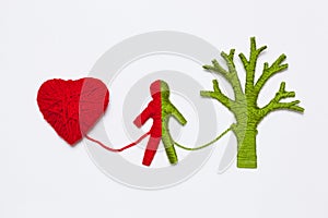 Yarn red heart, green tree and human figure