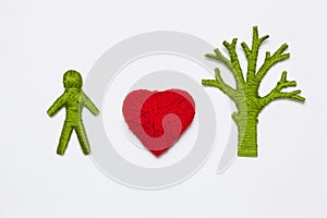 Yarn red heart, green tree and human figure