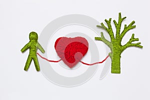 Yarn red heart, green tree and human figure