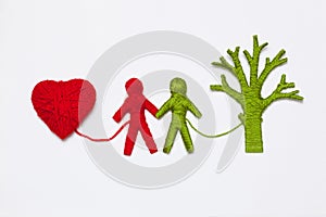 Yarn red heart, green tree and people figures isolated on white.
