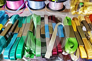 Yarn store, Passemanterie. Rolls with colorful ribbons white, gr