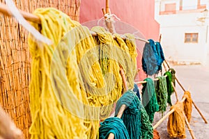 Yarns of colored wool freshly dyed by Arab craftsmen drying in the sun