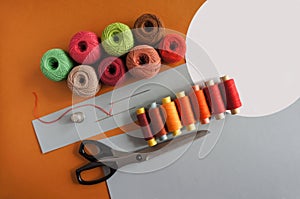 Yarns of threads for knitting in different colors on a yellow and grey