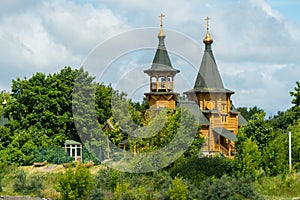 Yaroslavl region, Russia, July 10, 2023. Wooden temple among green vegetation.