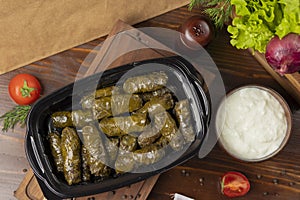 Yarpaq dolmasi, yaprak sarmasi, green grape leaves stuffed with meat takeaway.