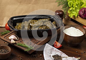 Yarpaq dolmasi, yaprak sarmasi, green grape leaves stuffed with meat takeaway.