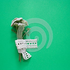 Yarrow flower on the green background with copy space. Medicinal plant.