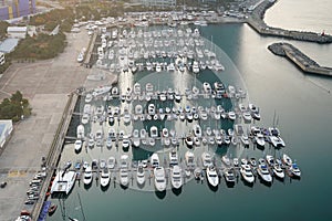 Yatch harbor marina pier and boat dock yatchs and vessels awaiting the open sea. Aerial drone view looking straight down above T-