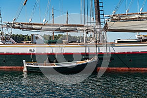 Yawl Boat Tied to Side of Wooden Schooner