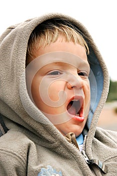 Yawning baby-boy isolated over white