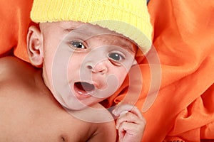 Yawning Baby with a Yellow Hat