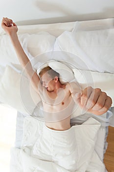 Yawning man in bed