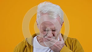 Yawning mature man on bright background closeup, vitamin deficiency, tiredness