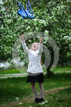 Yay, vacation! Happy girl in school uniform cheerfully throws up school bag. The concept of pre-school education