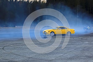 YCar drifting. Yellow sports car in the drifting competition