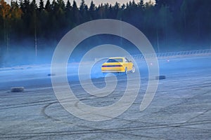 YCar drifting. Yellow sports car in the drifting competition