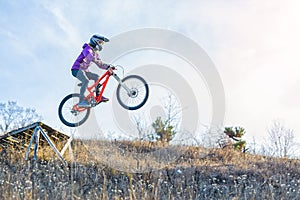?yclist is jumping from a high springboard, the sky and free space for your text.