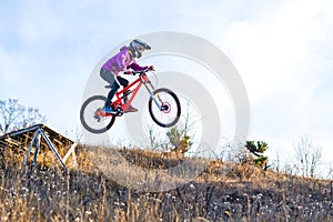 ?yclist is jumping from a high springboard, the sky and free space for your text.