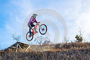 ?yclist is jumping from a high springboard, the sky and free space for your text.