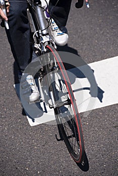 Ð¡yclist on the road bike crosses the street at pedestrian cross