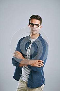 Yeah, I see you. a handsome man wearing glasses against a grey background.