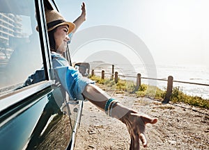 Yeah summer. a young woman enjoying a road trip along the coast.