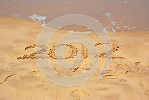 Year 2012 written in sand