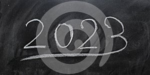 Year 2023 written on a blackboard with chalk