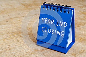 Year end closing text on blue notepad with customizable space for text. Closing concept.