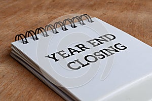 Year end closing text on white notepad. Year end closing concept