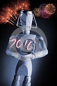 Year 2016, manikin mannequin human artist drawing model holding a wine cork on black background with fireworks.