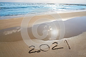 year 2021 numbers spell written on beach