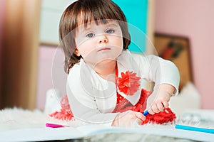 1 year old baby girl drawing with pencils at home