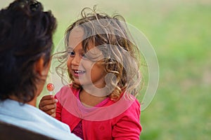 3-4 year old blond girl looks at her mother