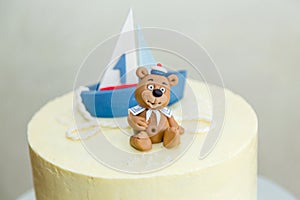 1 year old boy birthday cake with boat and sailor teddy bear for sea party