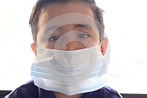 6-year-old Latino boy with covid-19 prevention mask photo