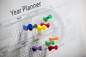 Year planner with thumbtacks