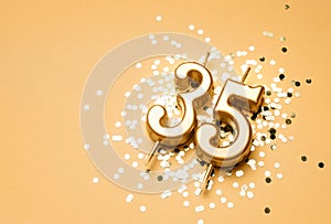 35 years birthday celebration festive background made with golden candle in the form of number Thirty five