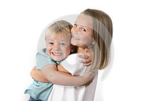 7 years old adorable blond happy girl posing with her little 3 years old brother smiling cheerful isolated on white background