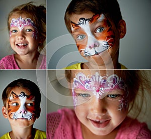 6 years old boy with blue eyes face painting of a cat or tiger. Pretty exciting blue-eyed girl of 2 years with a face