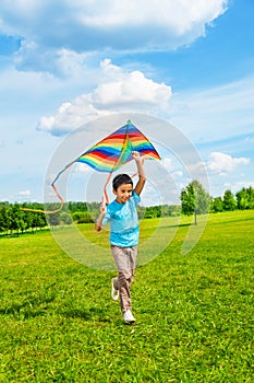 6 years old boy running with kite