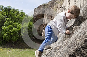 3 years old child boy climbing rock