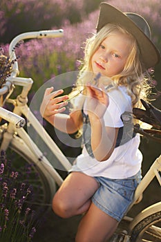 Girl on bicicle lavender photo