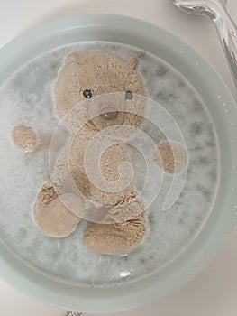 Teddy bear taking a bath
